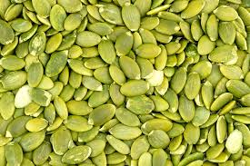large pile of green, unshelled pumpkin seeds.